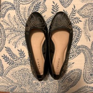 Black faux leather flats with gold studs. 8W
